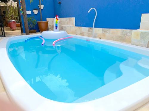 a large swimming pool with a blue pool at VELINN Pousada Praia do Perequê in Ilhabela
