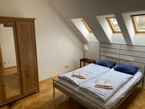a bedroom with a bed with two towels on it at Apartment Florenc in Prague