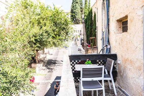 a table and chairs on the balcony of a building at La Casetta in Nazareth