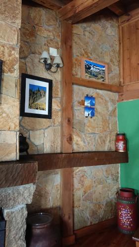 a stone wall with two shelves in a room at Artesano II in Navarredonda de Gredos