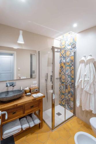 a bathroom with a glass shower and a sink at Accademia 39 in Sorrento