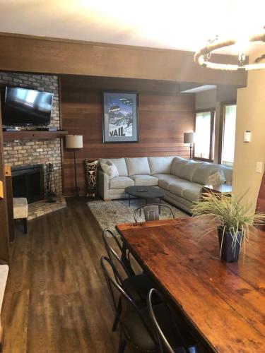 a living room with a couch and a table at Vail Racquet Club Mountain Resort in Vail