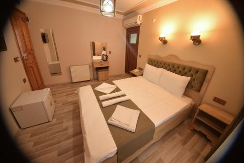 a small room with a bed and a table at Hotel Orkide in Istanbul