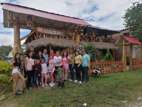 a group of people posing for a picture in front of a building at Cabañas Guacari San Agustín huila in San Agustín