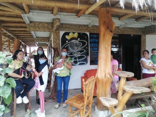 a group of people wearing masks in front of a restaurant at Cabañas Guacari San Agustín huila in San Agustín