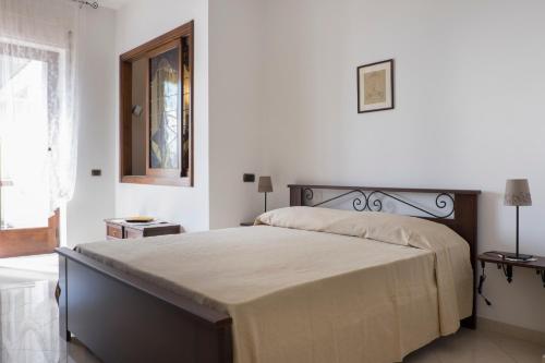 a bedroom with a large bed in a white room at Minori Apartment in Minori