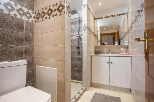 a bathroom with a toilet and a shower at Kamara Antica Apartments in Rhodes Town