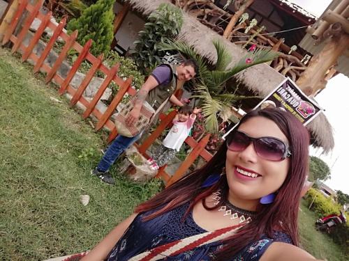 a woman in sunglasses posing for a picture with a child at Cabañas Guacari San Agustín huila in San Agustín