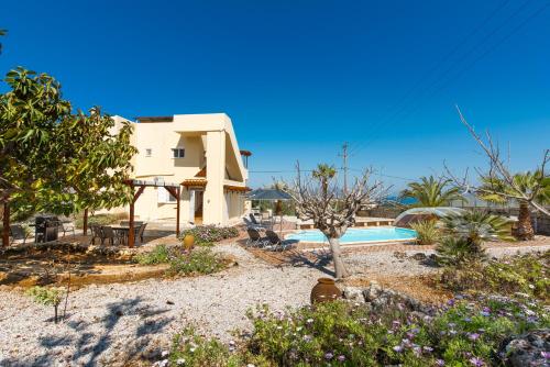 a villa with a swimming pool and a house at Plaque Panoramic SeaView Villa in Chania Town