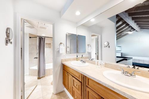 a bathroom with two sinks and a large mirror at Poolside Getaway Permit# 4610 in Palm Springs