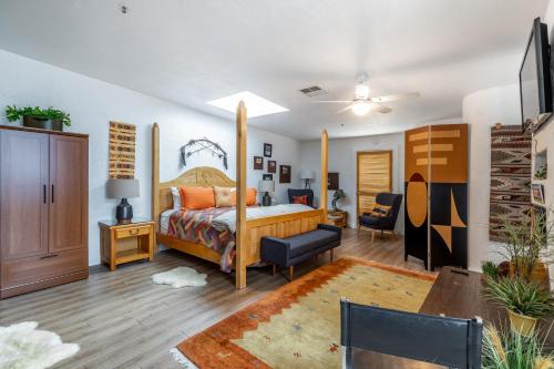 a bedroom with a canopy bed and a living room at Sunny Cozy Condo in St. George