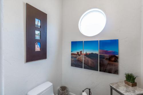 a bathroom with three pictures on the wall at Sunny Cozy Condo in St. George