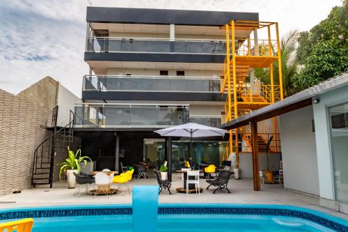 a house with a swimming pool and a building at Pousada Maanaim Porto in Porto De Galinhas
