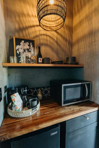 a kitchen counter with a microwave and a lamp at The Waves at Cane Bay in Kingshill