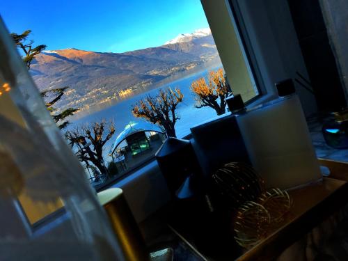 a window with a view of a mountain at Fall In Love with Como Lake in Bellano