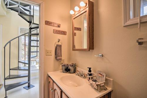 a bathroom with a sink and a mirror at Lakefront Table Rock Getaway with Private Swim Dock! in Golden
