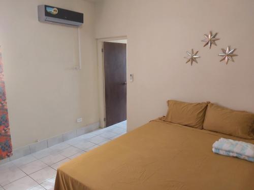 a bedroom with a bed with a brown blanket at Ocean View Apartments By-BLR in Bridgetown