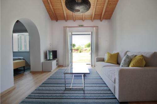 a living room with a couch and a table at Quinta da Luz - A Luxury Boutique B&B in Silves