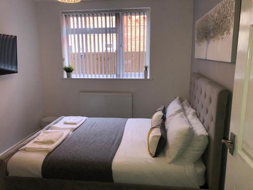 1 cama en un dormitorio con ventana en Coastal Retreat - Skegness en Skegness