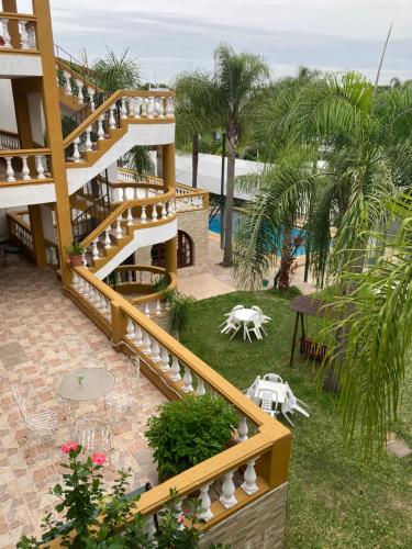 a staircase leading up to a resort with a pool at Casablanca Termal Apart-Hotel in Termas del Daymán