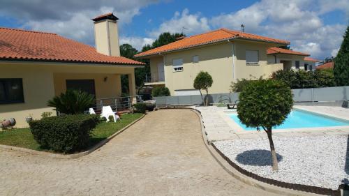a house with a swimming pool in front of a house at Casa de Água levada in Picarouba