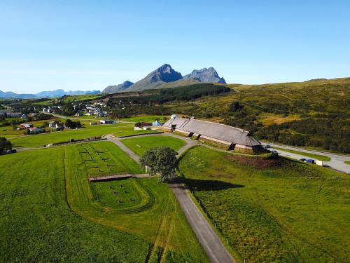 an aerial view of a farm with a barn and a road at Eagle Bay Lofoten in Gravdal