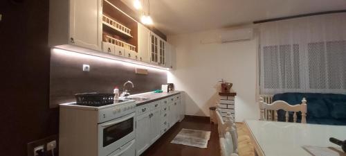 a kitchen with a stove and a sink and a tub at Apartman EXCLUZIV in Prijedor