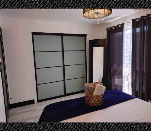 a bedroom with a large window and a basket on a bed at The Villas Beach House in Rosarito