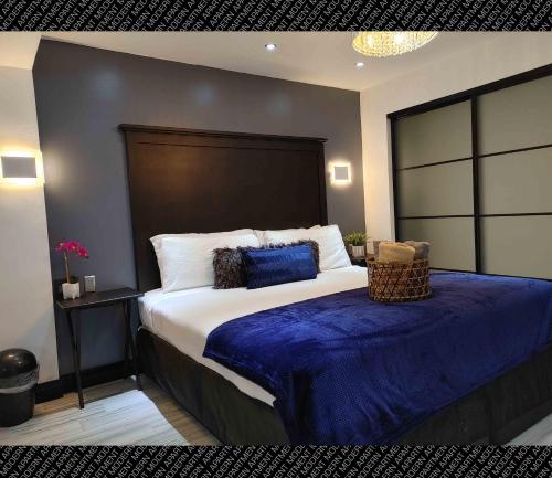 a bedroom with a large bed with a blue blanket at The Villas Beach House in Rosarito