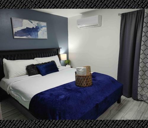 a bedroom with a bed with a blue blanket at The Villas Beach House in Rosarito