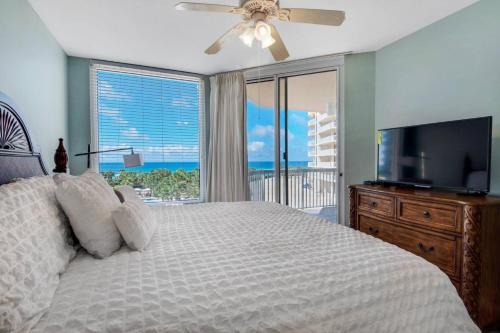a bedroom with a bed and a flat screen tv at Silver Shells-St. Croix #405 in Destin