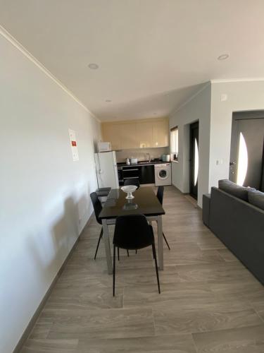 a kitchen and living room with a table and a couch at Casa da Sacota - Douro View in Baião