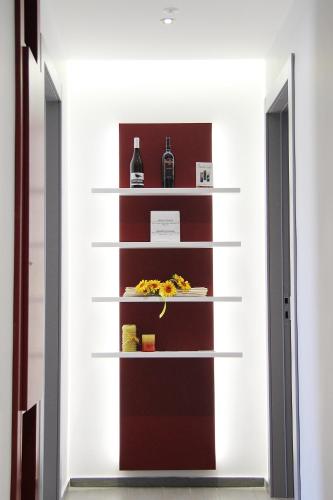 a shelf with food and wine bottles on it at Casa Vacanze Fardella Centrale in Trapani