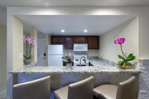 a kitchen with a white counter top and white cabinets at Best Western Plus Carpinteria Inn in Carpinteria