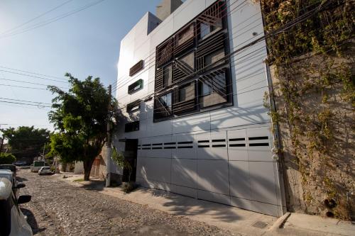 a white building with a window on the side of it at Lofts Santa Fe in Guadalajara