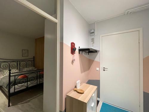 a room with a bedroom with a bed and a door at The cupcake apartment / Kuppikakkuyksiö in Turku