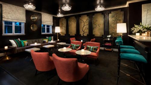 a restaurant with tables and chairs and a bar at Maison 140 Beverly Hills in Los Angeles