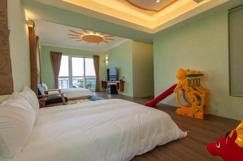 a bedroom with a large bed and a play equipment at Sea Dragonfly in Yanliau