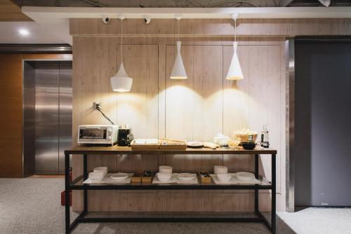 a display case with white dishes and a microwave at Hej Taipei in Taipei
