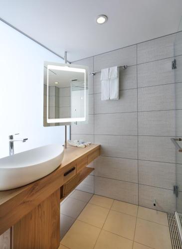 a bathroom with a sink and a mirror at SHIROYAMA HOTEL kagoshima in Kagoshima