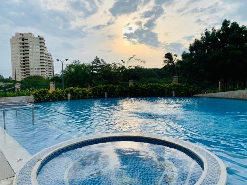 a large swimming pool with a large blue pool at ZAZUE - Bello Horizonte - By INMOBILIARIA VS in Santa Marta