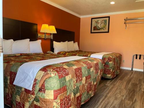 two beds in a hotel room with two at Budget Motel in Mountain View