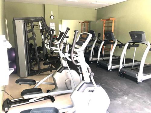 a gym with a bunch of cardio machines in it at Charmoso Flat em Itaipava, 509 Mangabeiras. in Petrópolis