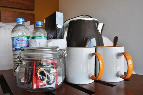 a counter with two coffee mugs and a tea kettle at The Canoe in Negombo