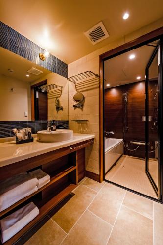 a bathroom with a sink and a shower at PROSTYLE TERRACE NAHA in Naha