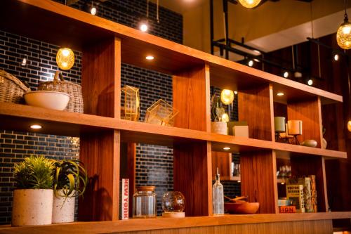 a book shelf in a restaurant with plants on it at PROSTYLE TERRACE NAHA in Naha