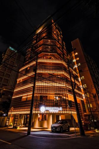 a building with a car parked in front of it at PROSTYLE TERRACE NAHA in Naha