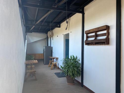 a room with a patio with a table and chairs at La Hacienda Rooms & Food in Jacó