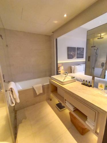 a bathroom with a sink and a bath tub at Riverview Suites Taipei in Taipei