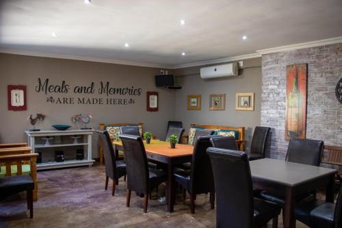 a dining room with a table and chairs at Bel Tramonto in Bloemfontein